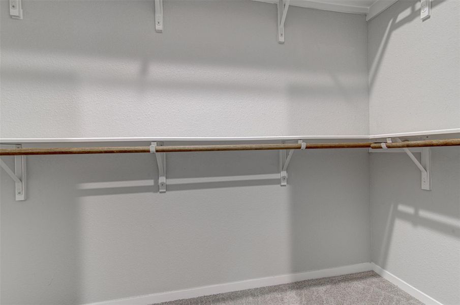 Ample shelving and hanging space characterize this well-appointed walk-in closet. Ample shelving and hanging space characterize this well-appointed walk-in closet.