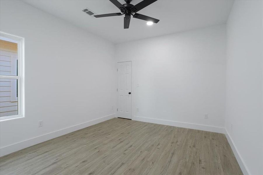 Empty room featuring ceiling fan and light hardwood / wood-style floors