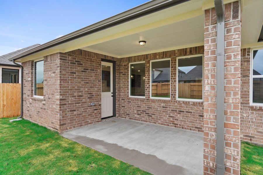 The covered patio is generously sized, providing ample space for various outdoor activities.