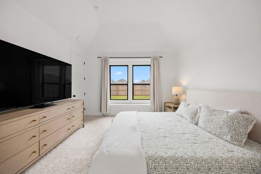 The vaulted ceiling here give you a grand feel in the primary bed.