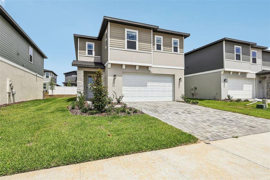 Front exterior of a new home in Cyrene at Minneola, Minneola, FL, highlighting curb appeal (Image 21).