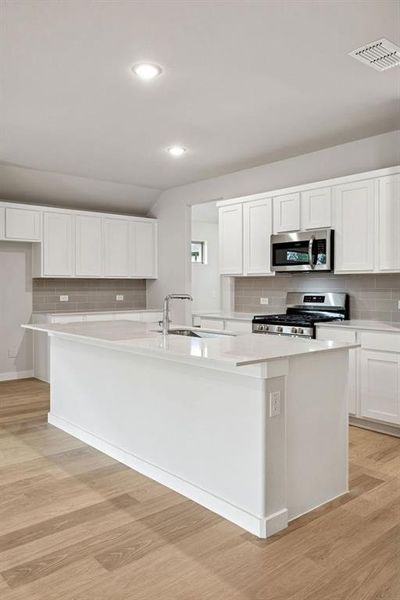 Kitchen in the Heisman home plan by Trophy Signature Homes – REPRESENTATIVE PHOTO