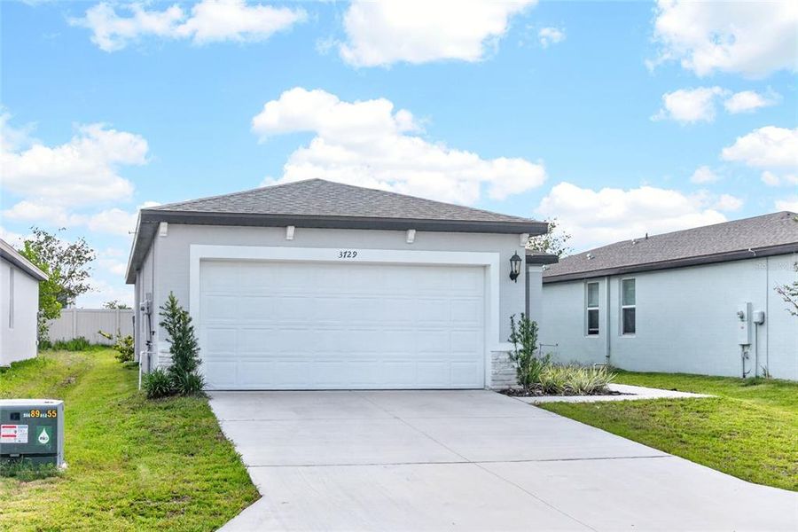Front exterior of a new home in Park East, Plant City, FL, highlighting curb appeal (Image 23). Front exterior of a new home in Park East, Plant City, FL, highlighting curb appeal (Image 23).