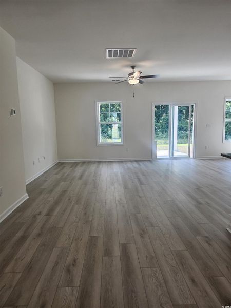 Unfurnished living room featuring ceiling fan and LVP floors