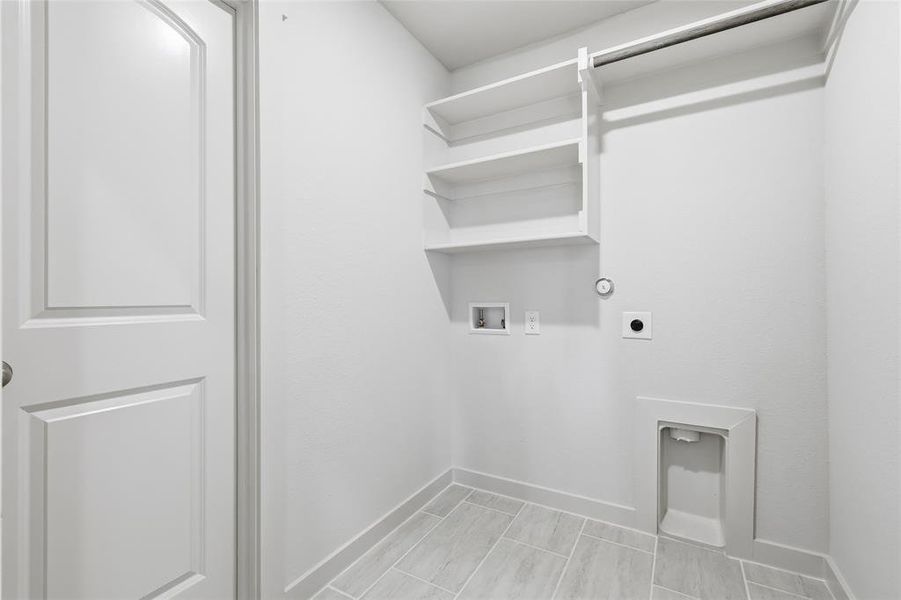 Washroom with washer hookup, electric dryer hookup, and hookup for a gas dryer