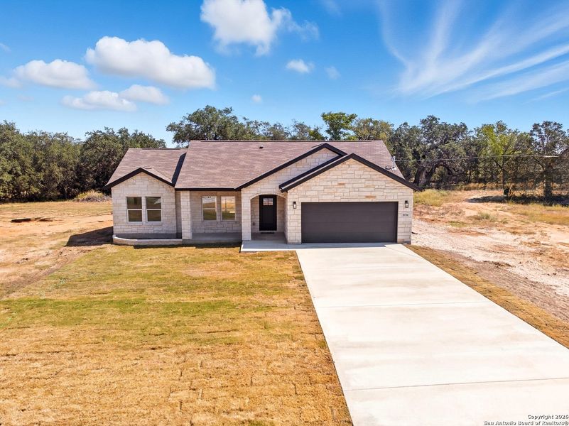 Front exterior of a new home in , Atascosa, TX, highlighting curb appeal (Image 17).