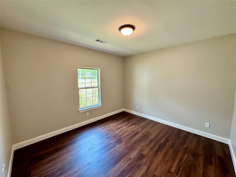 Empty room featuring hardwood / wood-style floors