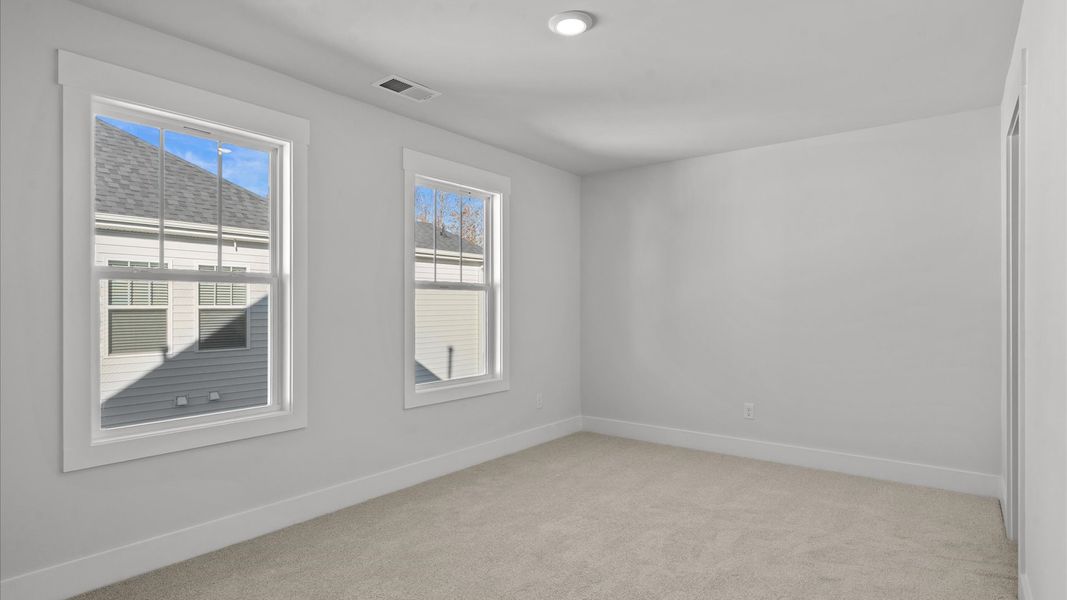 Accomplished design shines in this carpeted bedroom with a functional walk-in closet Accomplished design shines in this carpeted bedroom with a functional walk-in closet