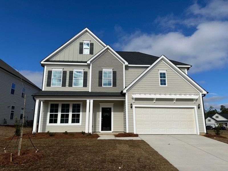 Front exterior of a new home in Pebble Branch, Chapin, SC, highlighting curb appeal (Image 1). Front exterior of a new home in Pebble Branch, Chapin, SC, highlighting curb appeal (Image 1).