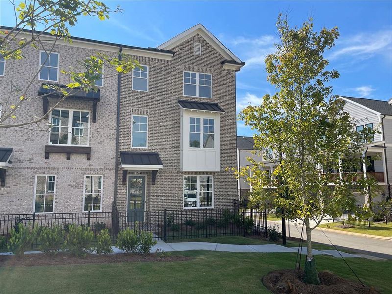 Front exterior of a new home in Waterside Townhomes, Peachtree Corners, GA, highlighting curb appeal (Image 20). Front exterior of a new home in Waterside Townhomes, Peachtree Corners, GA, highlighting curb appeal (Image 20).