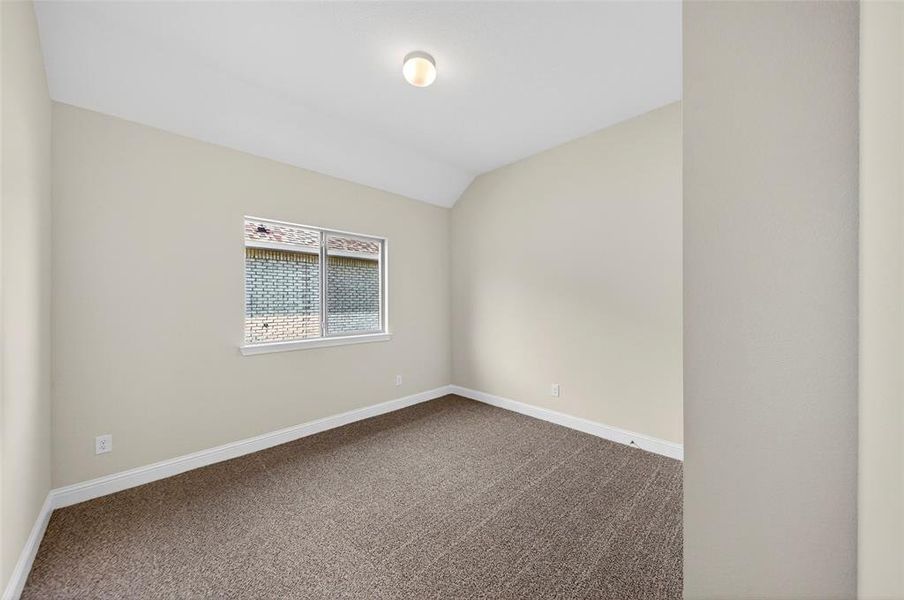Neutral-toned interior room featuring light beige walls and textured brown carpeting