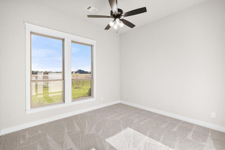 Unfurnished room with carpet and ceiling fan