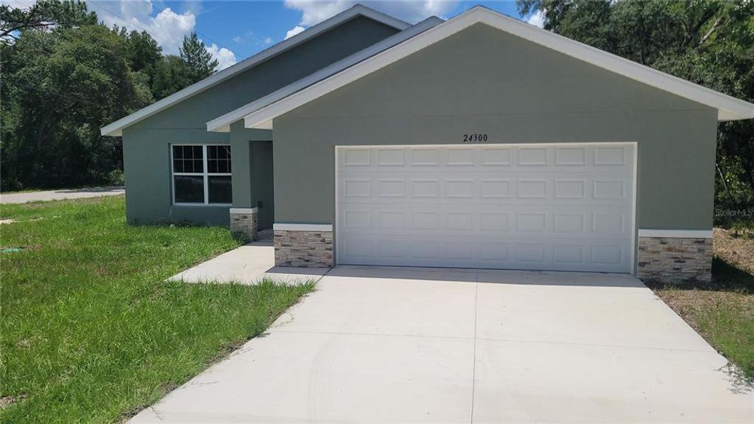 Front exterior of a new home in , Dunnellon, FL, highlighting curb appeal (Image 1).