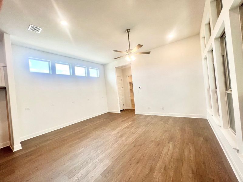 Unfurnished bedroom with wood finished floors and a ceiling fan Unfurnished bedroom with wood finished floors and a ceiling fan