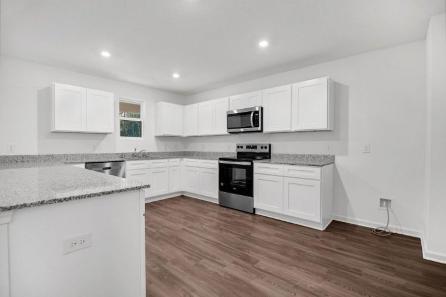 A kitchen with white cabinets. A kitchen with white cabinets.