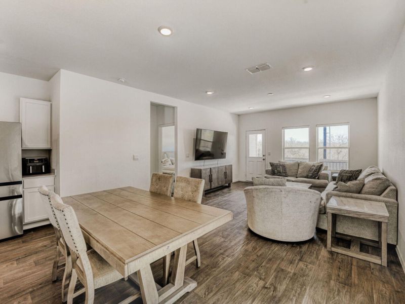 Dining area featuring dark wood finished floors and recessed lighting