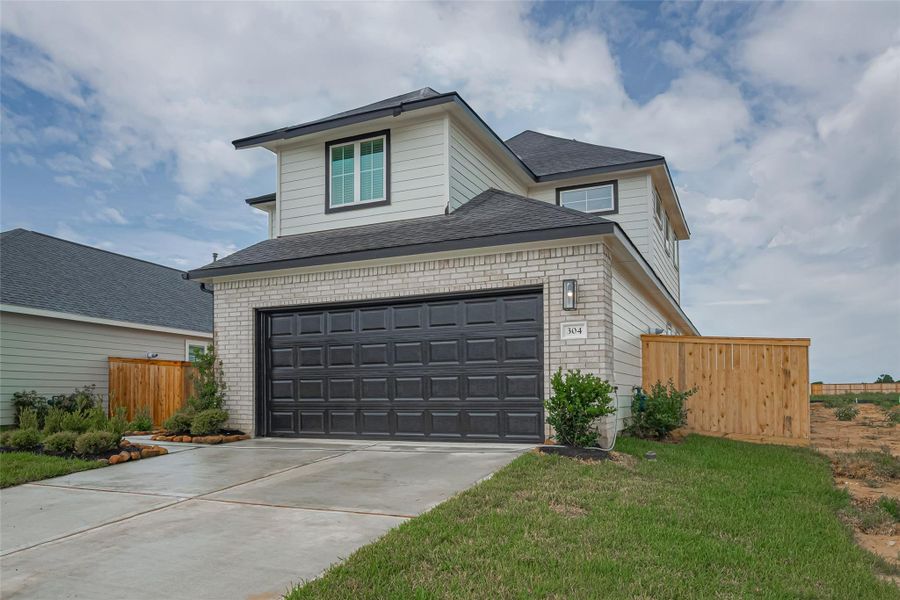 Front exterior of a new home in La Segarra, Brookshire, TX, highlighting curb appeal (Image 1).