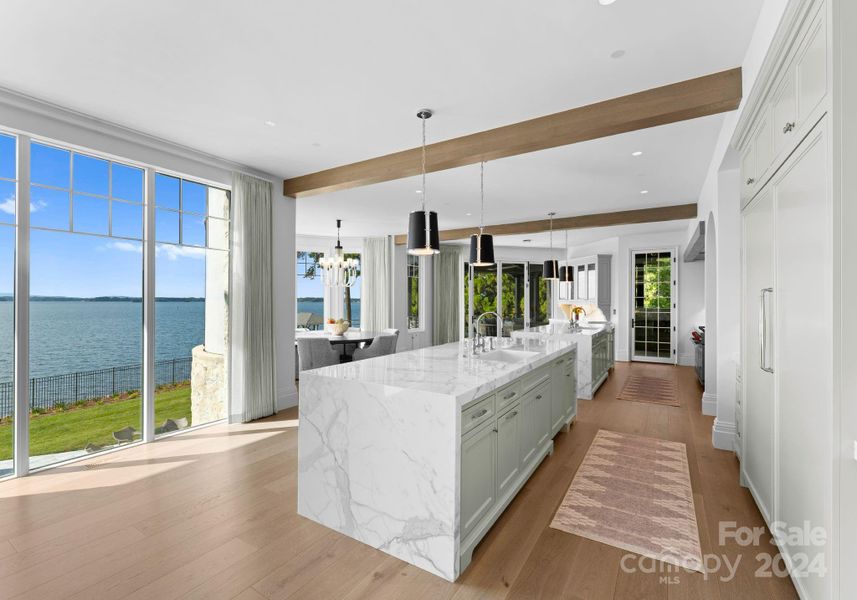 Stunning kitchen with two islands and integrated appliances with cabinet panels for a seamless aesthetic.