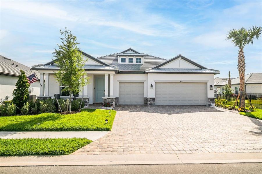 Front exterior of a new home in Sweetwater at Lakewood Ranch, Bradenton, FL, highlighting curb appeal (Image 26).