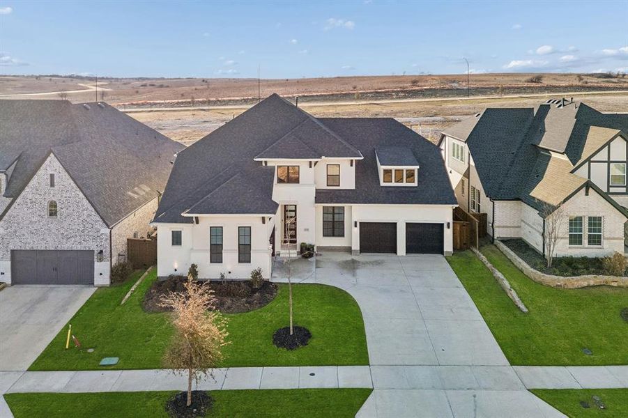 Front exterior of a new home in Walsh Ranch 70', Fort Worth, TX, highlighting curb appeal (Image 23). Front exterior of a new home in Walsh Ranch 70', Fort Worth, TX, highlighting curb appeal (Image 23).