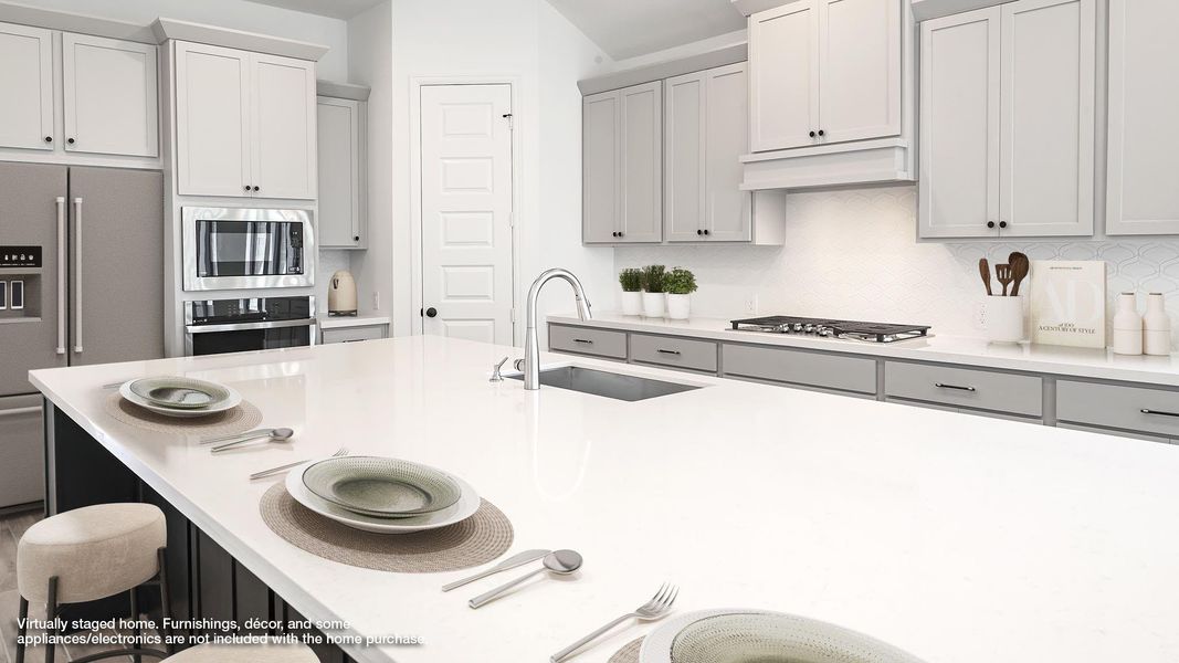 Kitchen with appliances with stainless steel finishes, tasteful backsplash, a breakfast bar, and light stone countertops Kitchen with appliances with stainless steel finishes, tasteful backsplash, a breakfast bar, and light stone countertops