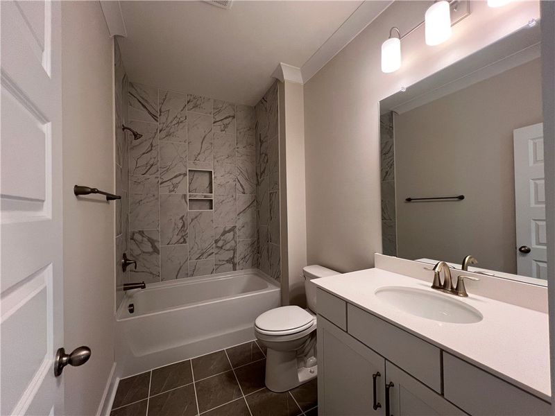 This bathroom features a contemporary vanity and a