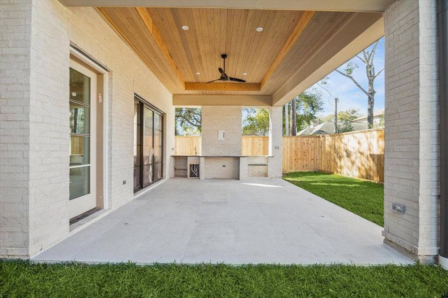 Expansive pavilion with high ceilings and T&G wood ceiling. A finished out summer kitchen w/ Coyote grill, stainless steel doors, sink and refrigerator to be installed. New fence, sprinkler system, gutters and drainage.