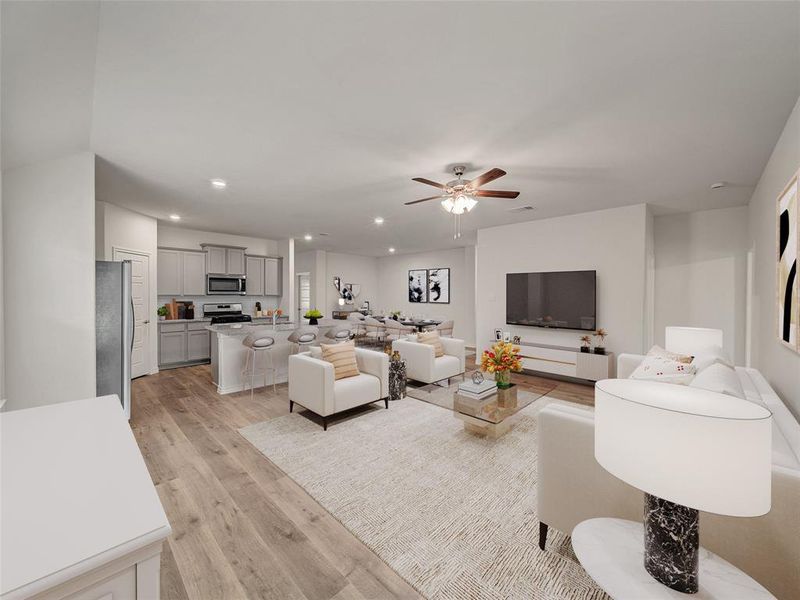 Living area with recessed lighting, a ceiling fan, and light wood finished floors