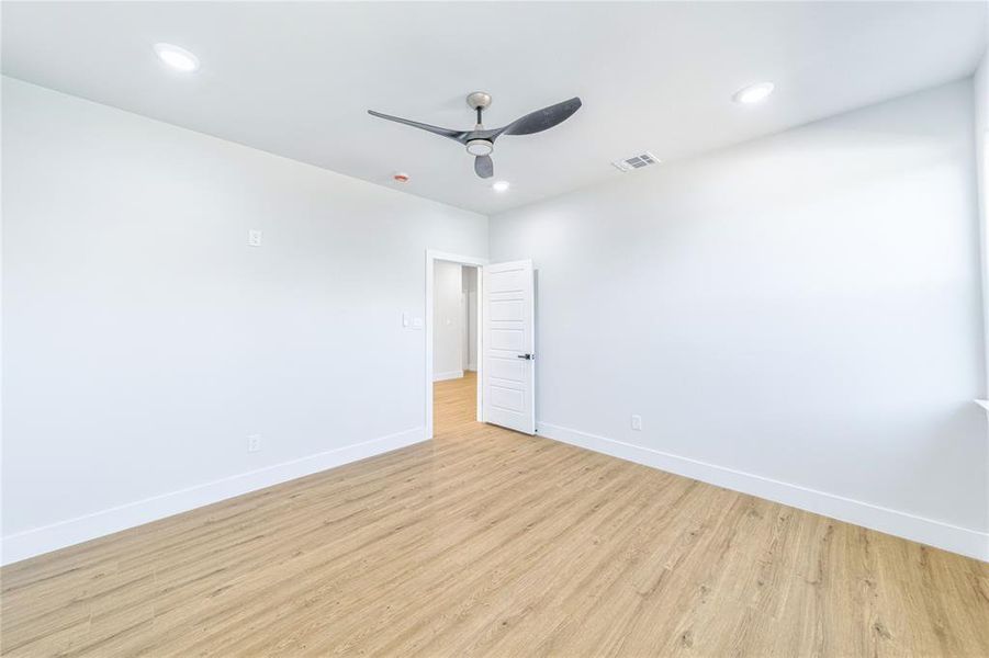 Unfurnished room featuring light wood finished floors, recessed lighting, and a ceiling fan Unfurnished room featuring light wood finished floors, recessed lighting, and a ceiling fan