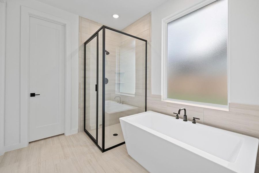 Full bathroom featuring a soaking tub, a shower stall, tile walls, and recessed lighting Full bathroom featuring a soaking tub, a shower stall, tile walls, and recessed lighting