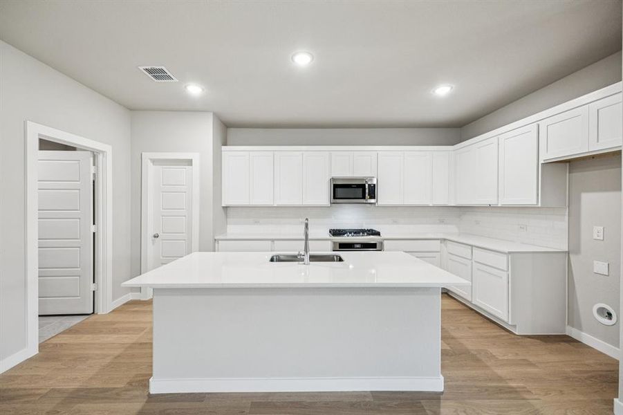 Kitchen in the Oscar home plan by Trophy Signature Homes – REPRESENTATIVE PHOTO Kitchen in the Oscar home plan by Trophy Signature Homes – REPRESENTATIVE PHOTO