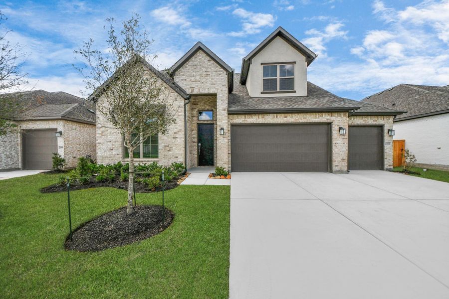 Front exterior of a new home in Marvida, Cypress, TX, highlighting curb appeal (Image 1).