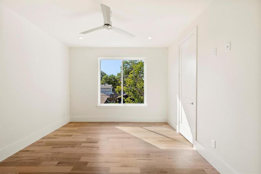 Empty room featuring ceiling fan and light hardwood / wood-style floors