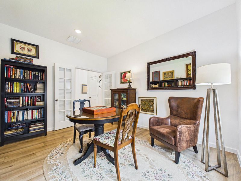 This office space is tucked away from the rest of the rooms and double glass french doors add additional privacy  and a sound barrier.