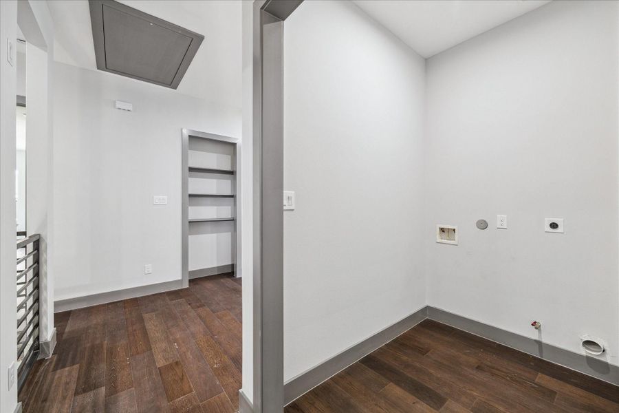 Washer and dryer connections with built-in shelving make the upstairs laundry area both functional and efficient, while its placement near the bedrooms simplifies household tasks.