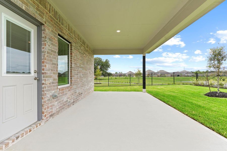 The extended covered patio offers ample space for outdoor seating, grilling, or lounging—enjoy relaxing evenings or weekend gatherings with views of the lush backyard and scenic lake. The extended covered patio offers ample space for outdoor seating, grilling, or lounging—enjoy relaxing evenings or weekend gatherings with views of the lush backyard and scenic lake.