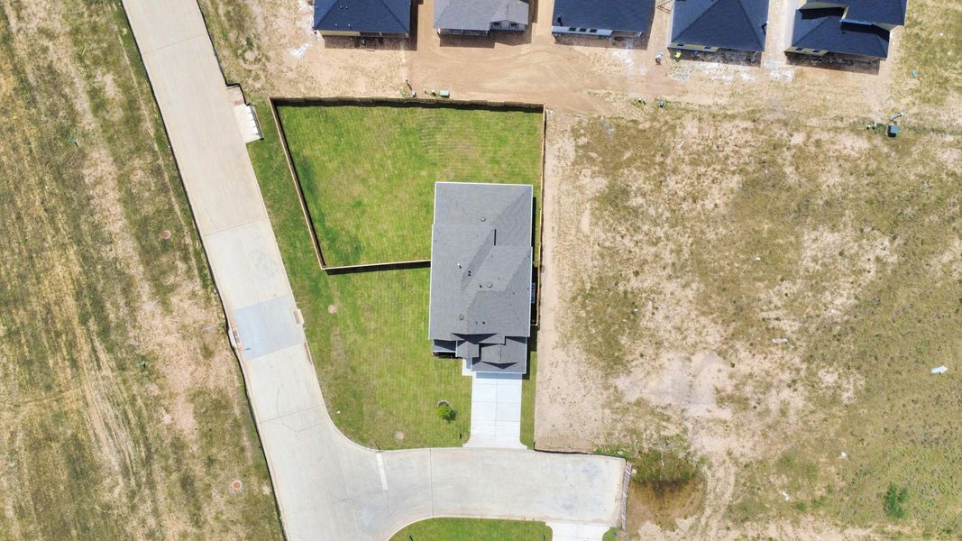 An aerial view of a spacious subdivision lot, highlighting a well-maintained yard and a fully fenced perimeter, offering both privacy and expansive outdoor space. An aerial view of a spacious subdivision lot, highlighting a well-maintained yard and a fully fenced perimeter, offering both privacy and expansive outdoor space.