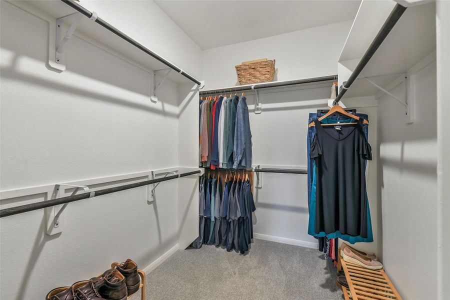 The generous walk in closet provides plenty of rods for hanging clothes, as well as upper shelving for additional storage!