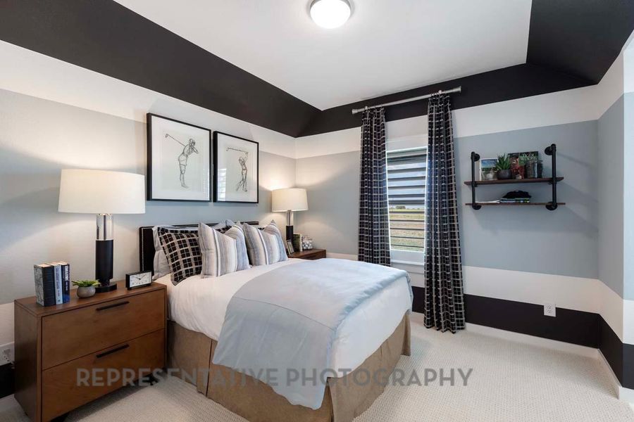 Bedroom featuring light carpet