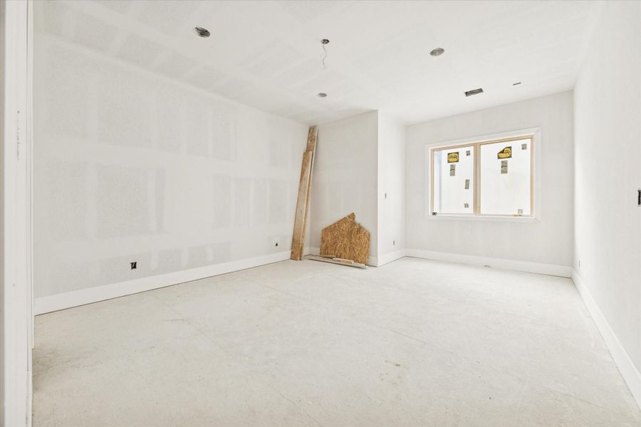 Bright and spacious secondary bedroom featuring high ceilings and sleek modern lines. Large windows provide an abundance of natural light, emphasizing the premium finishes and airy contemporary design found throughout the home. This versatile space offers a generous layout and clean aesthetic, perfect for a guest room, nursery, or secondary suite. Bright and spacious secondary bedroom featuring high ceilings and sleek modern lines. Large windows provide an abundance of natural light, emphasizing the premium finishes and airy contemporary design found throughout the home. This versatile space offers a generous layout and clean aesthetic, perfect for a guest room, nursery, or secondary suite.