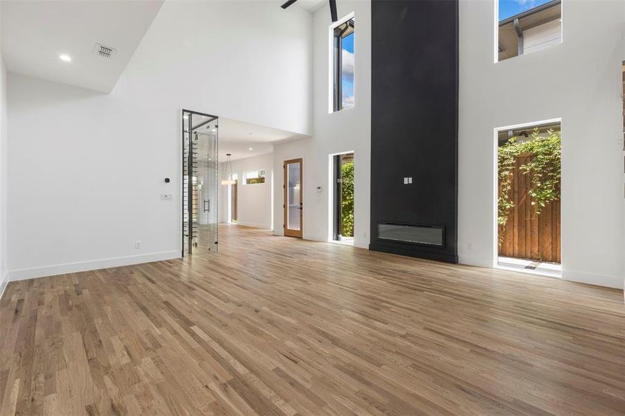 Unfurnished living room featuring light wood- Unfurnished living room featuring light wood-