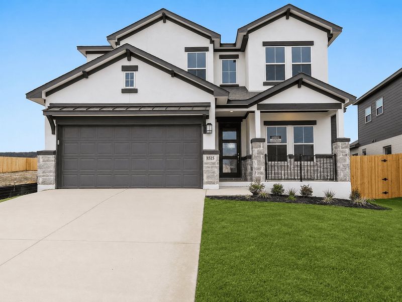 Front exterior of a new home in Lakeside at Tessera on Lake Travis, Lago Vista, TX, highlighting curb appeal (Image 1). Front exterior of a new home in Lakeside at Tessera on Lake Travis, Lago Vista, TX, highlighting curb appeal (Image 1).