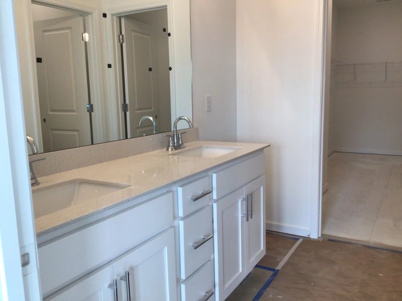 Primary Bath featuring the AW Collection® Coastal - Spa-like with white cabinets and light tile.