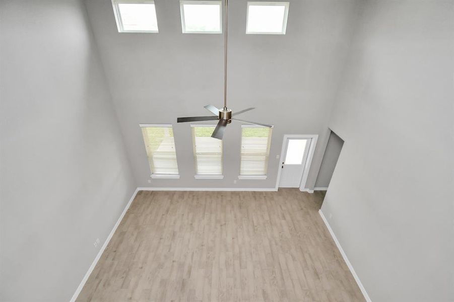 High Ceilings in this home, view from game room above. Sample photo of completed home with similar plan. As built color and selections may vary.