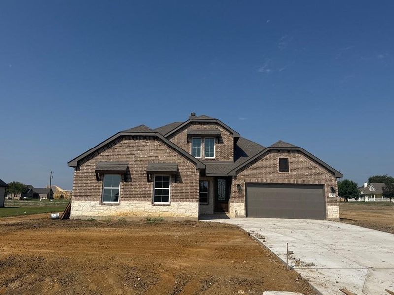 Front exterior of a new home in Fannin Ranch, Leonard, TX, highlighting curb appeal (Image 2).