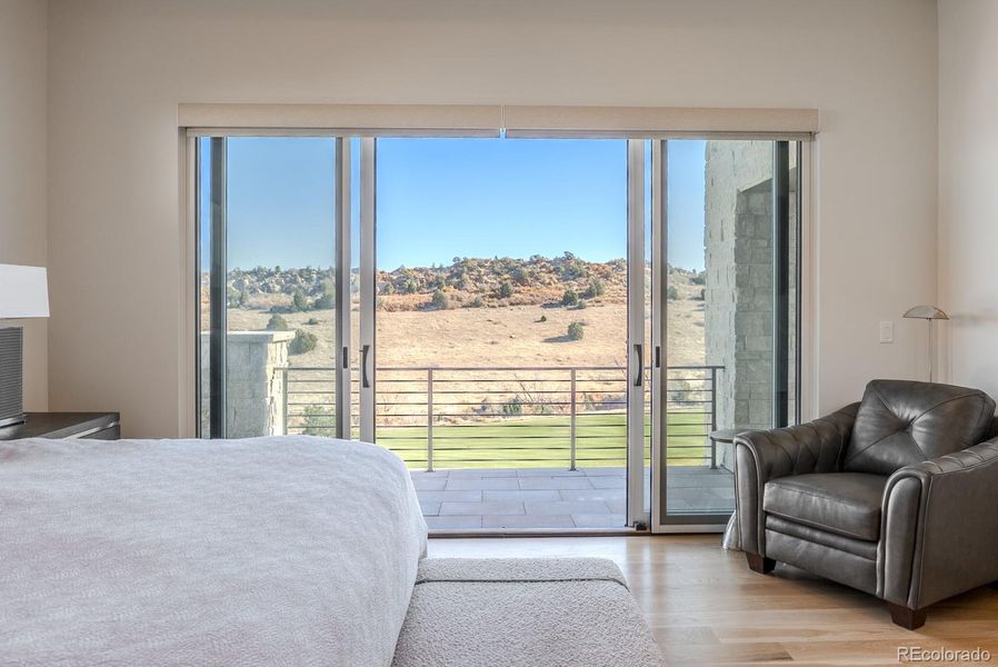 Automated tailored shades, wide-plank wood floors, and a softly coffered ceiling amplify the atmosphere of effortless luxury.