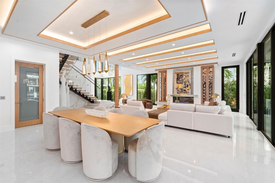 Surrounded by large windows, this elegant space is filled with natural light and offers panoramic scenes of the waterway and lush tropical landscape.