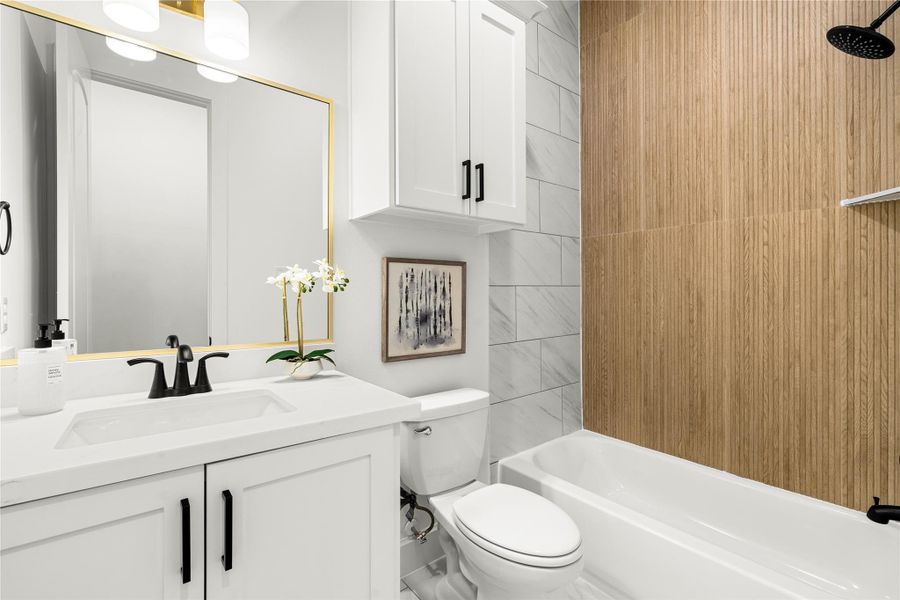 Stylish full bathroom on the second floor, serving multiple purposes - perfect for guests or residents of the adjacent bedroom.