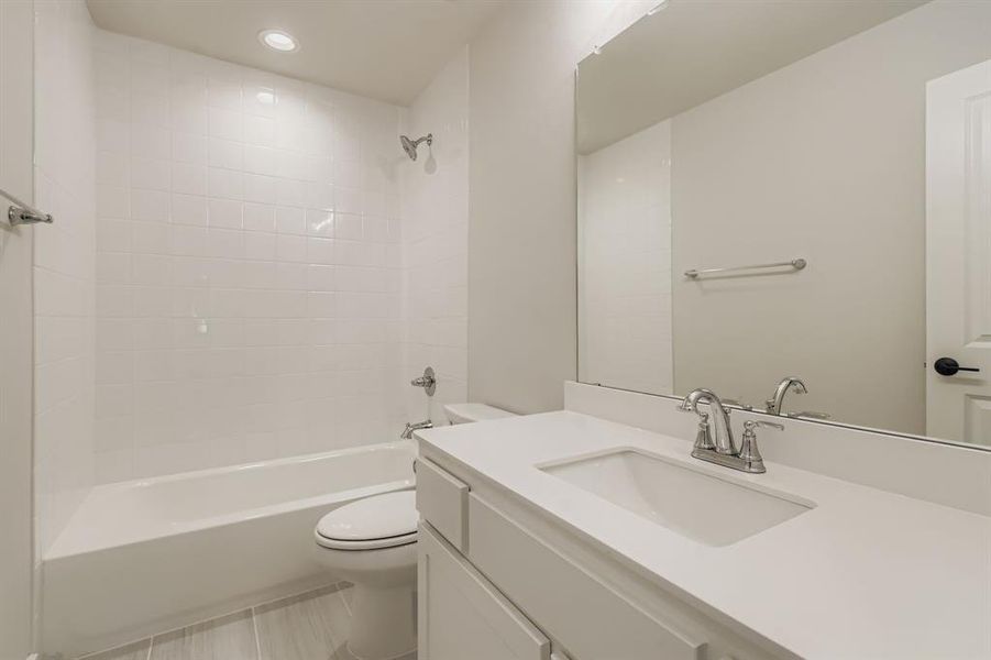 Full bath featuring vanity, shower / tub combination, and recessed lighting
