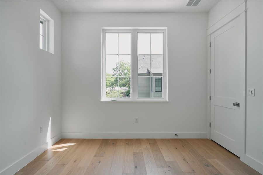 Empty room featuring light wood-type flooring and baseboards Empty room featuring light wood-type flooring and baseboards
